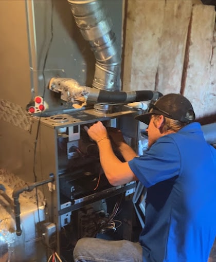 Rapid HVAC Tech working on a furnace in brentwood Tn